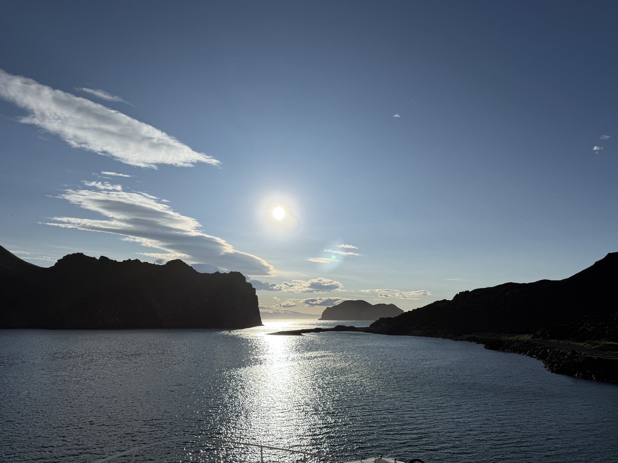 The ferry leaving for Vestmannaeyjar, cliffs covered in puffins