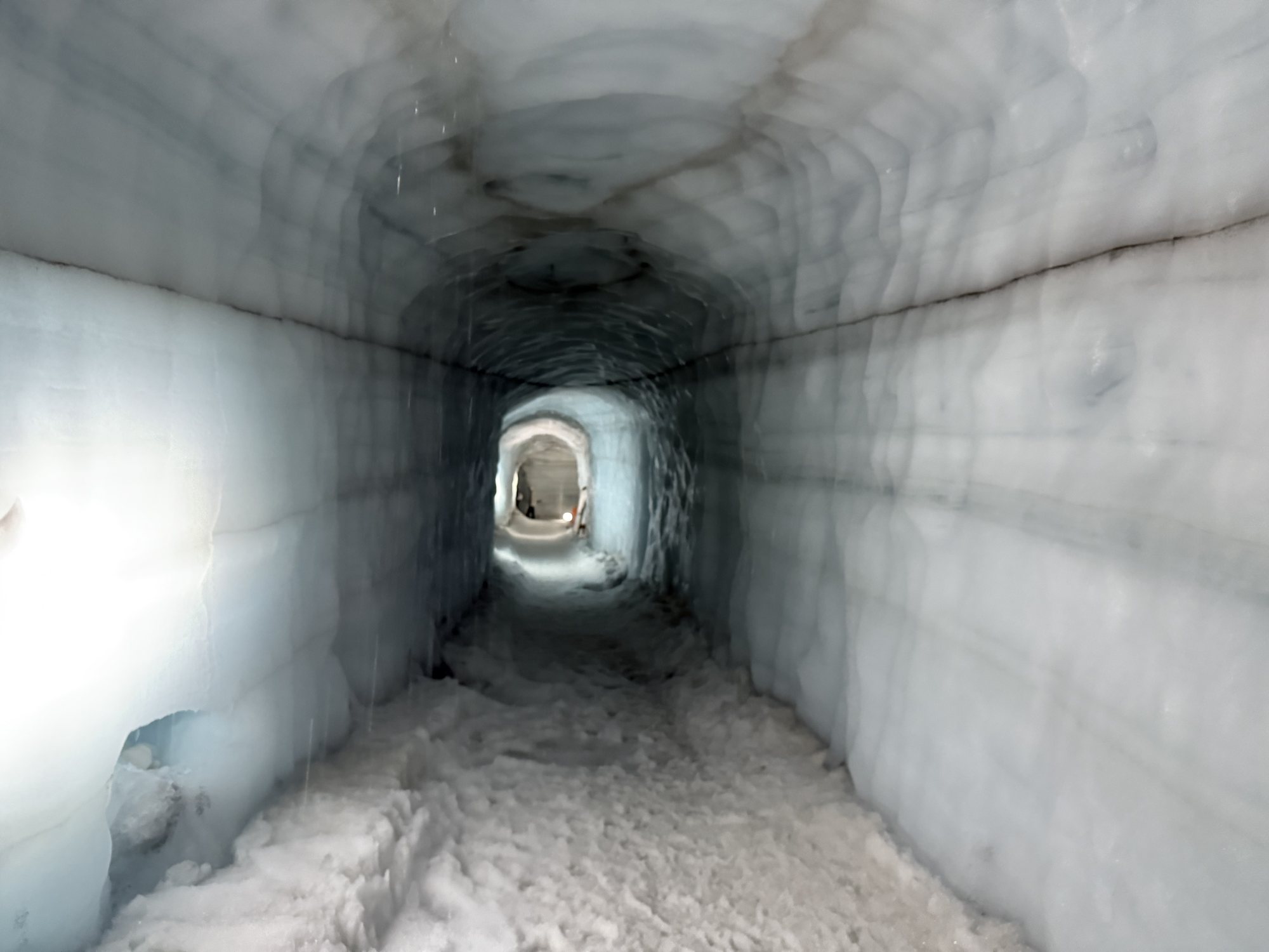 Glowing blue ice tunnels inside the Langjökull Glacier ice cave