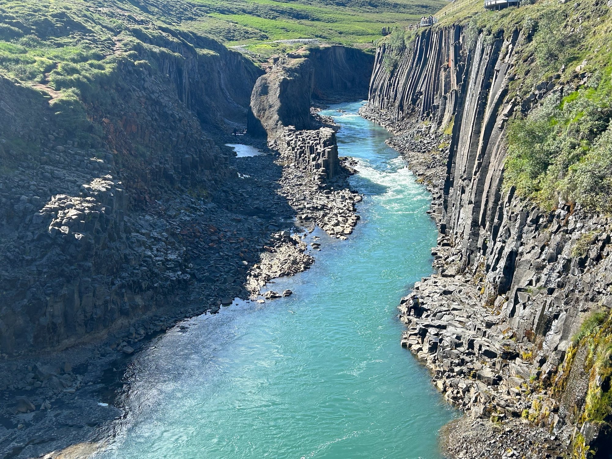 Studlagil Canyon's milky aqua river through basalt columns